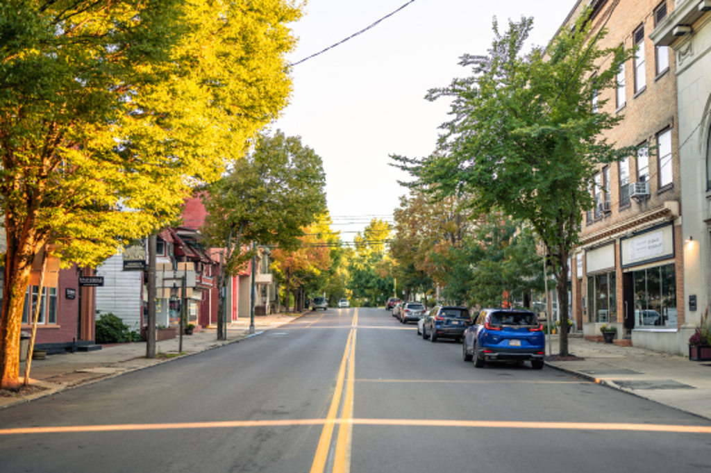 This image depicts a downtown street in Muncy, Pennsylvania at sunset.