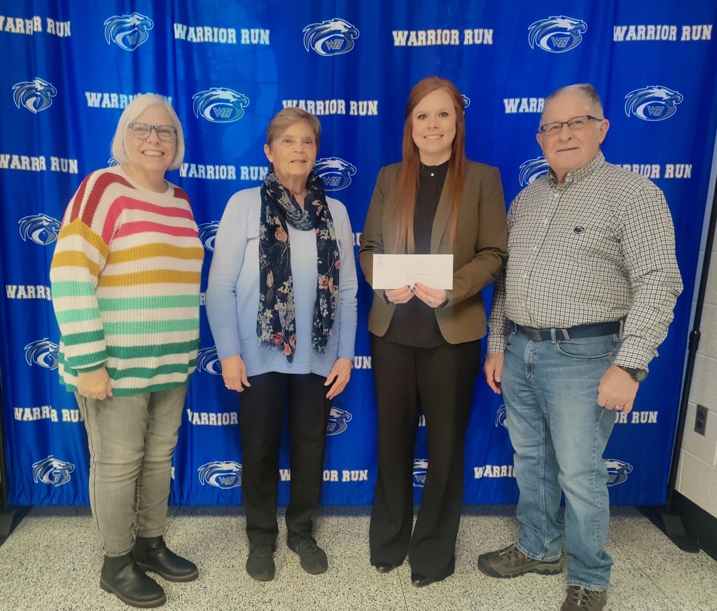 eitc warrior run check presentation stacey wheeler presenting an eitc check on behalf on Muncy Bank at Warrior Run School Districk alongside their faculty.