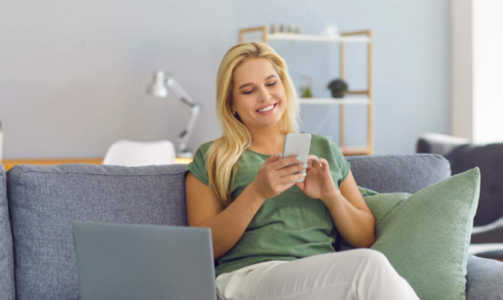 blonde girl on phone on couch