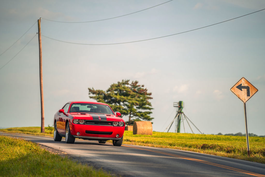 red mustang black stripe on country road