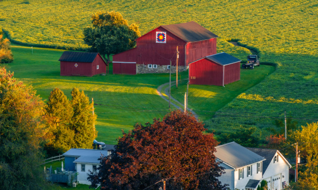 This image depicts a red barn in Muncy, Pennsylvania.
