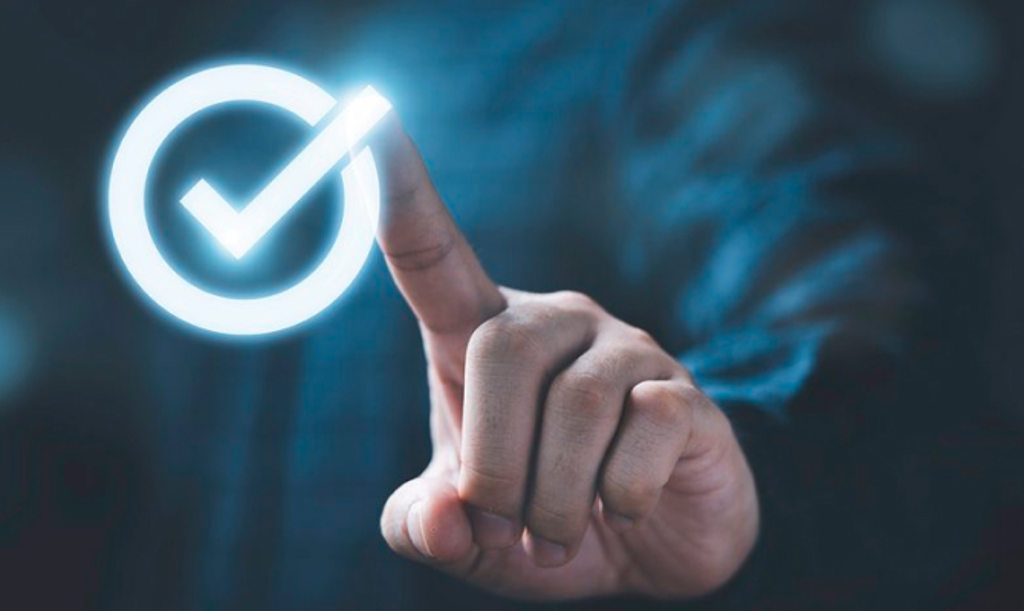 Positive Pay Image depicts a hand pressing a glowing check mark