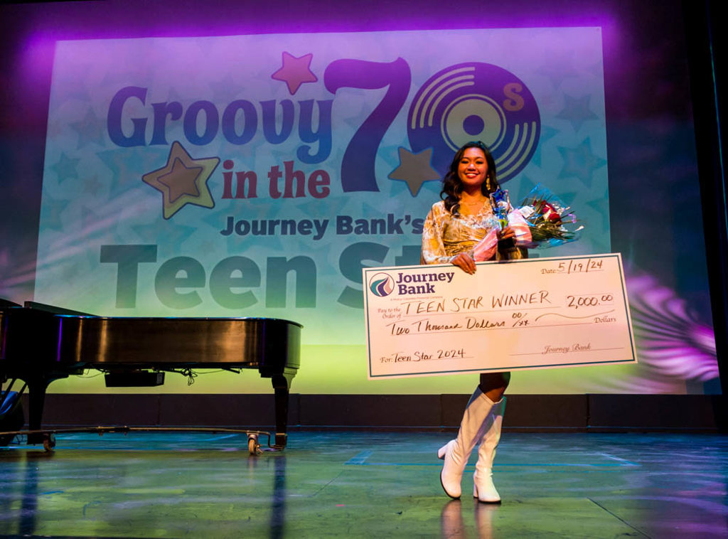 Maria blas, teen star winner, holding big check on stage