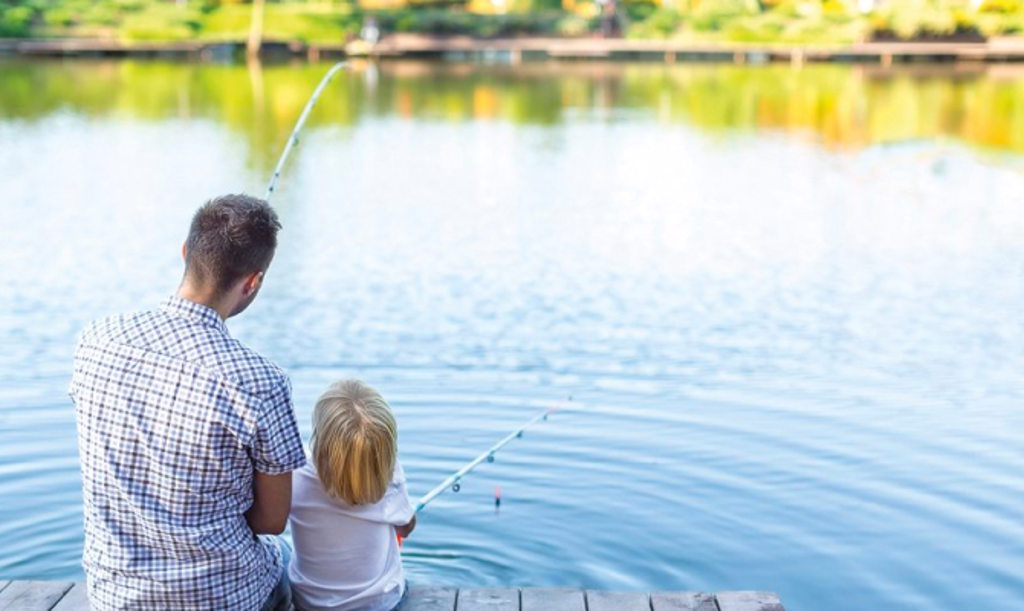 man and son fishing on dock