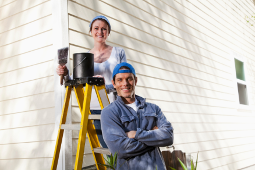myline couple painting outside of house